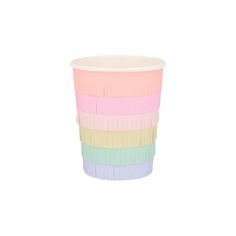 a multicolored paper cup sitting on top of a white table