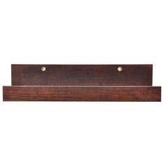 a wooden shelf with two brass knobs on it's sides and a white background