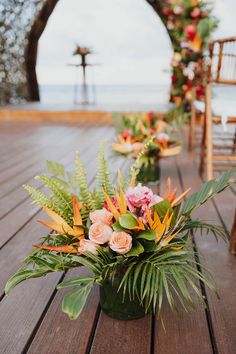 an outdoor ceremony set up with flowers and greenery