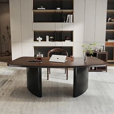 a modern office with an oval table and bookcases