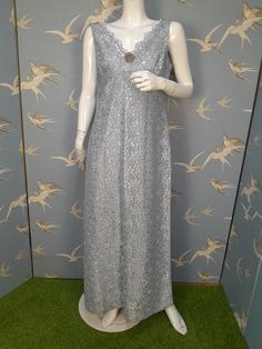 "Beautiful vintage silver blue metallic maxi dress made by Shubette of London in 1960s/ 70s. In an Empire line style, it`s sleeveless with a V-neckline and a deep V at the back. The skirt is full length and flares in a gentle A-line from the under bust seam. It has a pretty sparkly brooch at the centre front. Measures 38\" bust, 34\" under bust/ waist, 44\" hips. Length 55\" from shoulder to hem. There are a couple of small very faint marks on the bodice, close to the neckline, but they are too faint to show on the photos. Otherwise it`s in exceptionally good condition." Size 12 Uk, Lace Maxi, Lace Maxi Dress, Little Dresses, Vintage 60s, Silver Blue, Dress Clothes For Women, Vintage Silver, Dress Making