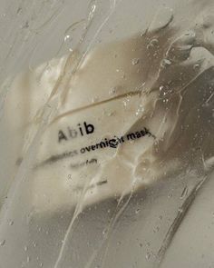 a close up view of the inside of a glass with water droplets on it and an adb logo