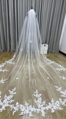 a wedding veil with white flowers on it