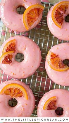 donuts topped with pink glaze and tiny orange sections Homemade Donuts Recipe, Baked Doughnuts, Slow Cooker Desserts, Doughnut Recipe, Delicious Donuts, Mini Donuts