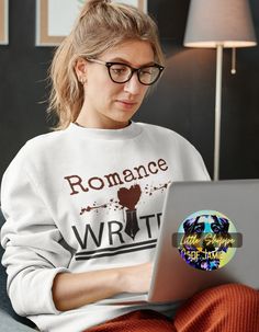 a woman sitting on a couch with a laptop computer in her lap and looking at the screen