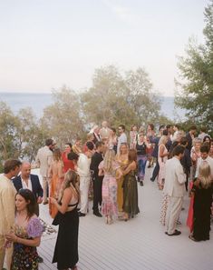 a group of people standing on top of a wooden deck