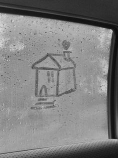 a drawing on the windshield of a car shows a house with a dog in it