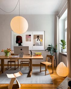 a living room filled with furniture and a laptop computer on top of a wooden table