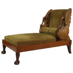 an antique chaise lounge chair with green fabric