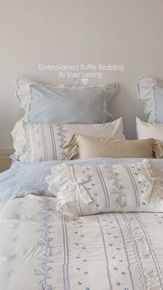 the bed is made with blue and white linens