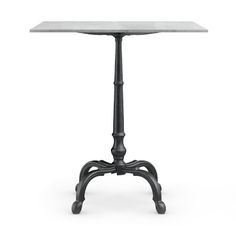 an old fashioned table with a glass top and metal legs, on a white background