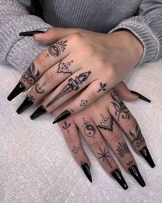 a woman's hand with black and white tattoos on it