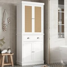 a bathroom with a white cabinet next to a bath tub