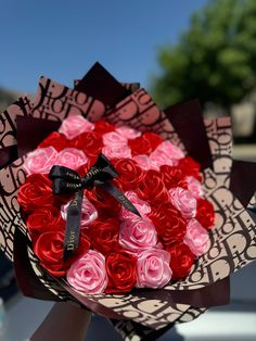 a bouquet of roses is being held by someone's hand in front of the camera