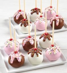 chocolate covered cake pops with sprinkles and toppings on a white tray