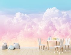 there is a wall mural with clouds in the sky and some chairs on the floor