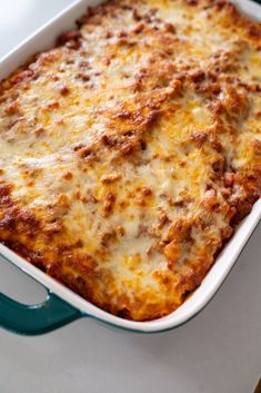 a casserole dish with cheese and meat in it