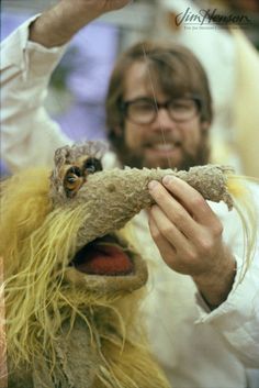 a man holding a stuffed animal in front of his face