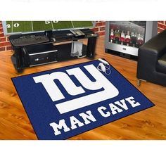 the new york giants man cave rug is shown in front of a tv and couch