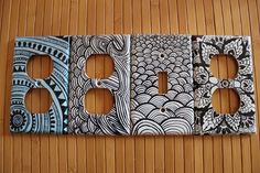 three light switch plates with designs on them