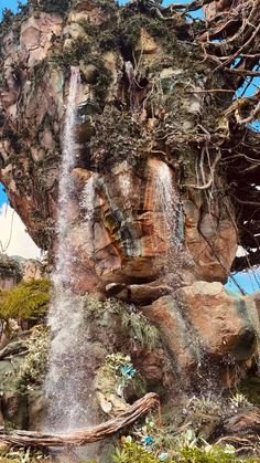 a large waterfall in the middle of a park