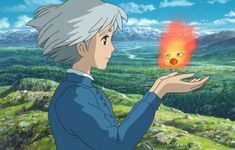 an anime character holding a fire ball in his hand and looking at the sky with mountains behind him