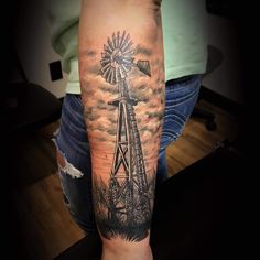 a man with a windmill tattoo on his arm