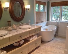 a large bathroom with two sinks and a tub