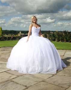 a woman in a white wedding dress posing for the camera