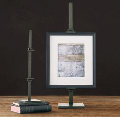 an easel and two books on a wooden table