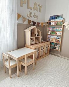 a child's play room with wooden furniture and bookshelves, including a doll house