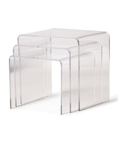 three clear acrylic nesting tables on white background