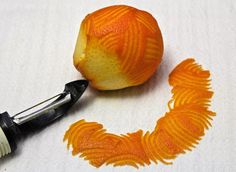 an orange and white ball of yarn next to a crochet hook