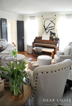 a living room filled with furniture and a piano