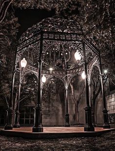 a gazebo lit up at night in the park