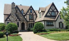 a large house with lots of windows and landscaping