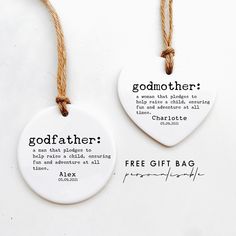 two white ceramic tags that say godfather and free gift bag on twine