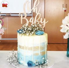 there is a cake that has been decorated with flowers and the words oh baby on it