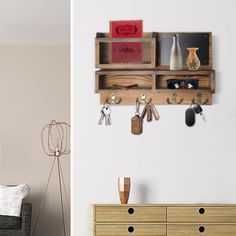 there is a wall mounted shelf with keys and other items on it in the living room