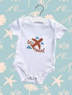 Baby's first travel embroidered baby vest. Made out of 100% cotton. Beautiful quality and super soft cotton baby bodysuit, baby grow or t-shirt. Please see the photos to choose colour of the thread.(you can add all the details with name in personalisation box) 🧵Personalisation: High Quality Embroidery. Personalisation takes 1-3 working days and we use only certified embroidery threads that are suitable for babies and children. 🧽CARE INSTRUCTIONS * This garment is delicately finished by hand so please wash inside out and on a cool wash. 📦Delivery: We can post items directly to the recipient with free gift message that will be printed on textured cardstock with lovely style font. Gift wrapping is available as well with a small extra charge. If your item is marked as a gift you will receiv Unisex White Short Sleeve Cotton Bodysuit, Unisex White Cotton Short Sleeve Bodysuit, White Short Sleeve Cotton Bodysuit, White Cotton Short Sleeve Bodysuit With Letter Print, White Cotton Crew Neck Onesie, White Cotton Top For Travel, First Time Flyer, Embroidery Threads, Baby Arrival