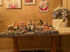 a table covered with lots of christmas decorations and figurines on top of it