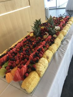 a long table topped with lots of fruits and veggies on top of it