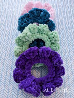 four different colored scrunffles sitting on top of a blue and white table