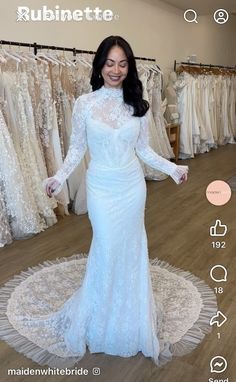 a woman in a white wedding dress standing on a rug with her hands out to the side