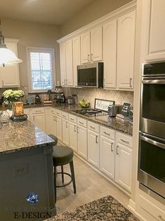 a kitchen with granite counter tops and white cabinets