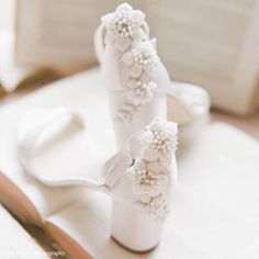 the bride's shoes are decorated with flowers and pearls on their wedding day,