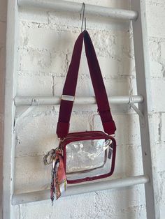 The perfect accessory for game day! Clear Stadium Bag Removable Scarf Detail Trendy Red Bags With Clear Strap, Red Rectangular Bag With Clear Strap, On-the-go Rectangular Shoulder Bag With Clear Strap, Square School Bag With Clear Strap, Square School Bags With Clear Strap, Red Bags With Clear Strap For Everyday Use, Rectangular Bags With Clear Strap For On-the-go, Burgundy Bag With Removable Pouch For On-the-go, Burgundy Bag With Adjustable Strap For On-the-go