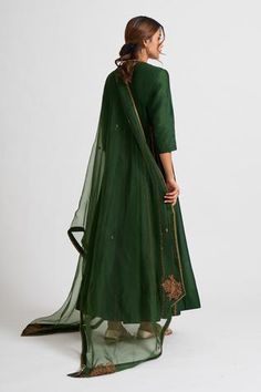 Olive green flared anarkali set in chanderi silk. Paired with an organza dupatta.
Components:3
Embroidery
Neckline:V-neck
Sleeve Length:Three Quarter
Fabric:Chanderi Silk, Organza
Color:Green
Placement embroidery on anarkali and dupatta - Aza Fashions V Neck Anarkali, Chanderi Anarkali, Dori Work, Anarkali Kurta, Organza Dupatta, Anarkali Suit, Bottle Green, Silk Embroidery, Set For Women