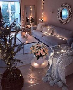 a living room filled with lots of furniture and christmas lights on the windows sill