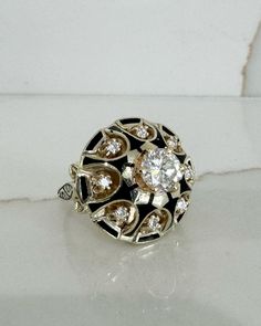 This 1950s vintage 1.0cttw. diamond and black enamel dome ring is a show stopper. It is made with 14K Yellow Gold, Diamond, and Black Enamel. Size 8.5 (can be sized upon request). Black Enamel Diamond Anniversary Ring, Round Black Enamel Diamond Ring For Anniversary, White Gold Enamel Ring With Diamond Accents, Formal Round Enamel Diamond Ring, Black Diamond Enamel Ring For Anniversary, Diamond Enamel Ring With Black Enamel, Vintage Round Diamond Enamel Ring, Vintage Diamond Enamel Round Ring, Gold Enamel Ring With Single Cut Diamonds